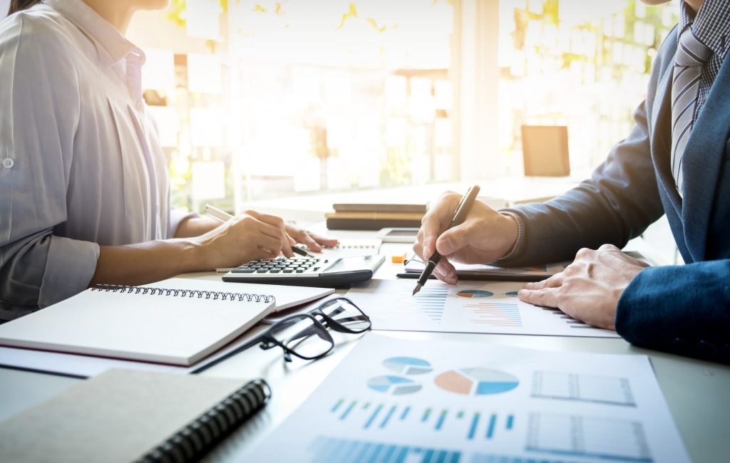 business man financial inspector and secretary making report, calculating or checking balance. Internal Revenue Service inspector checking document. Audit concept